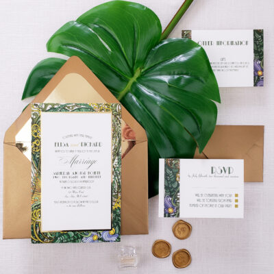 wedding invite in brown envelope with tropical border