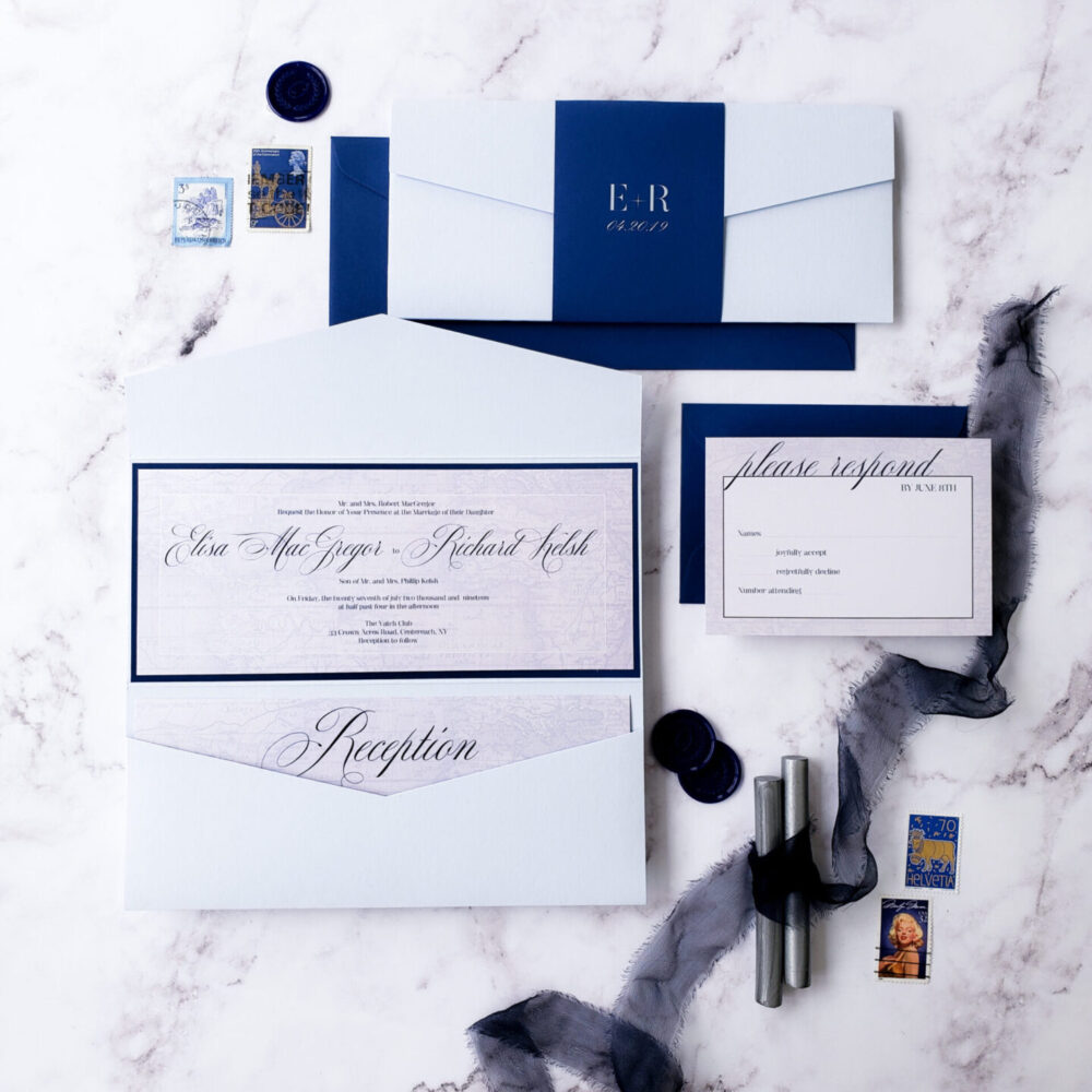 flatlay white envelope with blue bellyband and blue border