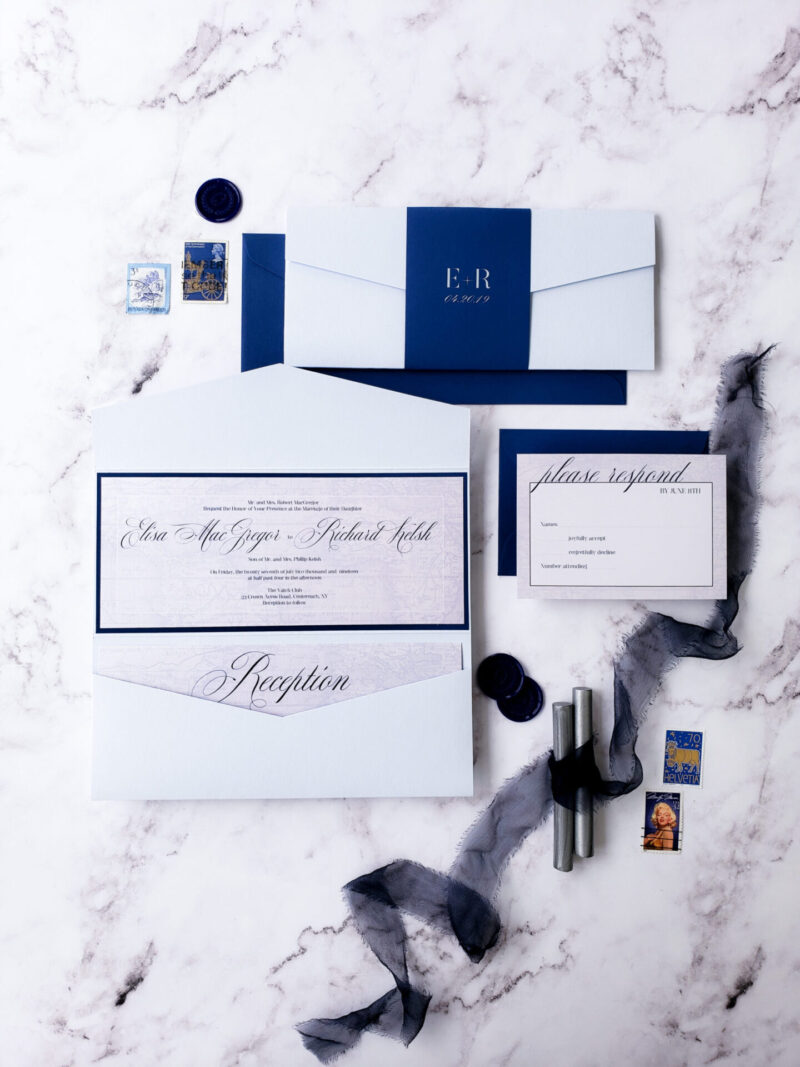 flatlay white envelope with blue bellyband and blue border