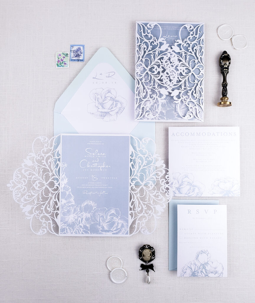periwinkle stationery and white border with white laser cut wedding invitation