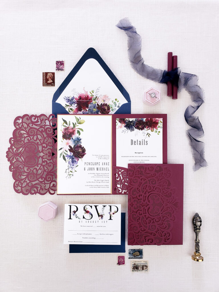 flatlay blue and maroon envelope with pattern and ribbon