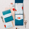 bright blue envelopes with pops of red and a wax seal flatlay