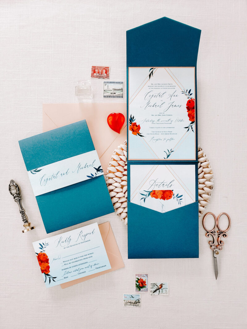 bright blue envelopes with pops of red and a wax seal flatlay