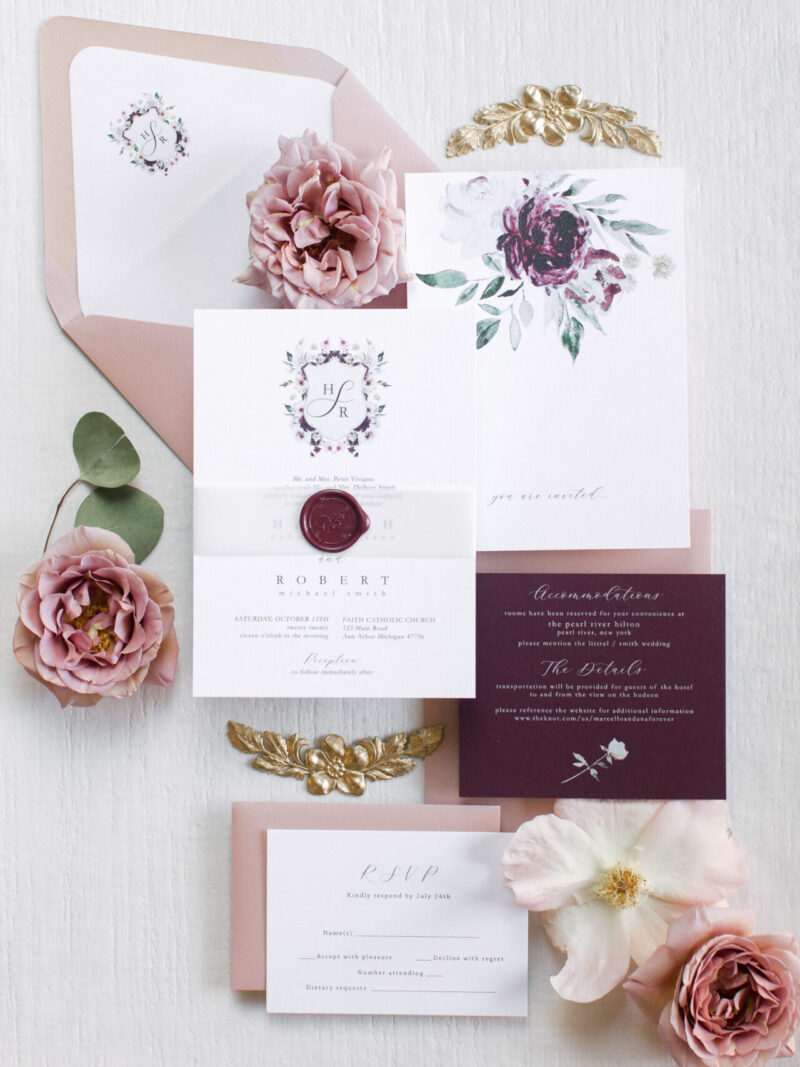 wedding invitation with maroon wax seal and bellyband