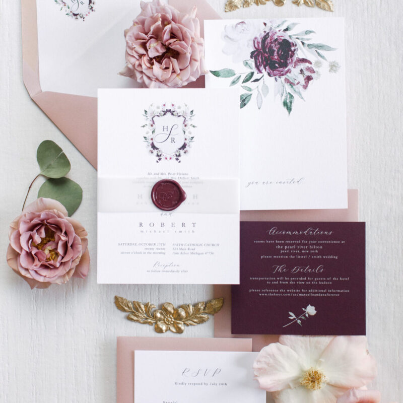wedding invitation with maroon wax seal and bellyband