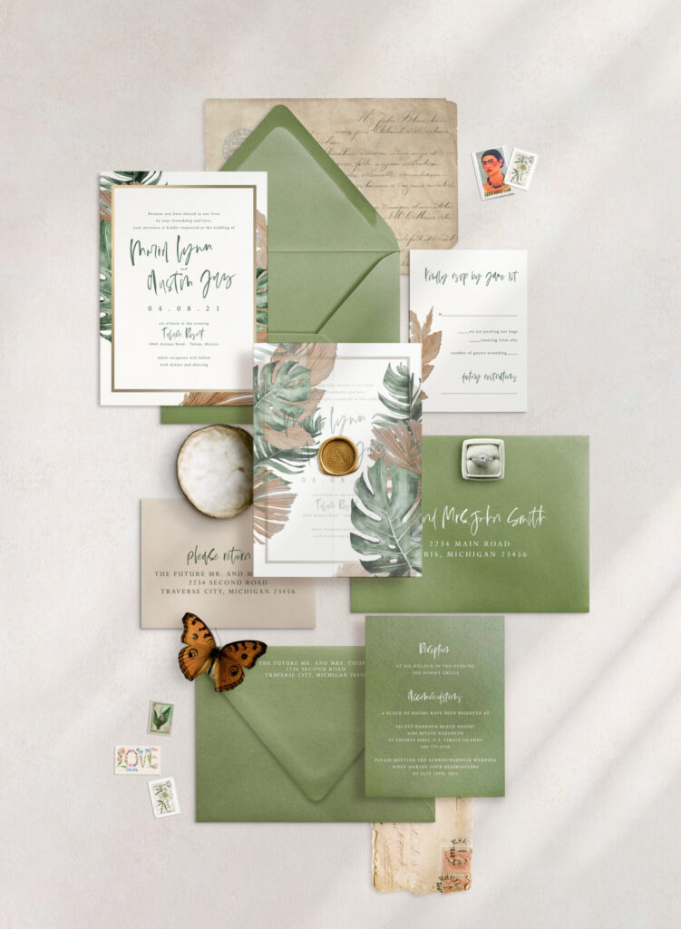 Tropical vellum wedding invitations featuring elegant palm leaves and floral motifs, perfect for destination and beach-themed weddings.