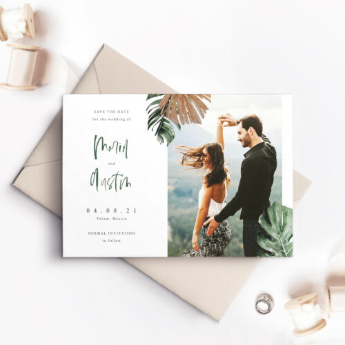 save the date card with picture of couple and ferns