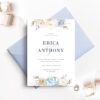 pale blue envelope with white save the date card and flowers