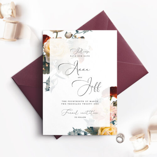 maroon envelope with white card and floral corner borders