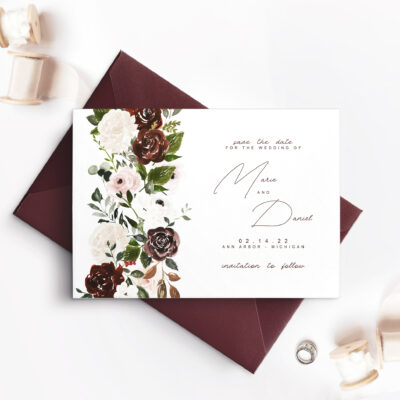 maroon envelope with white card and flowers