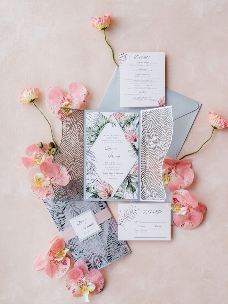 Tropical bohemian wedding invitations featuring pampas grass and lush floral motifs, perfect for destination weddings.