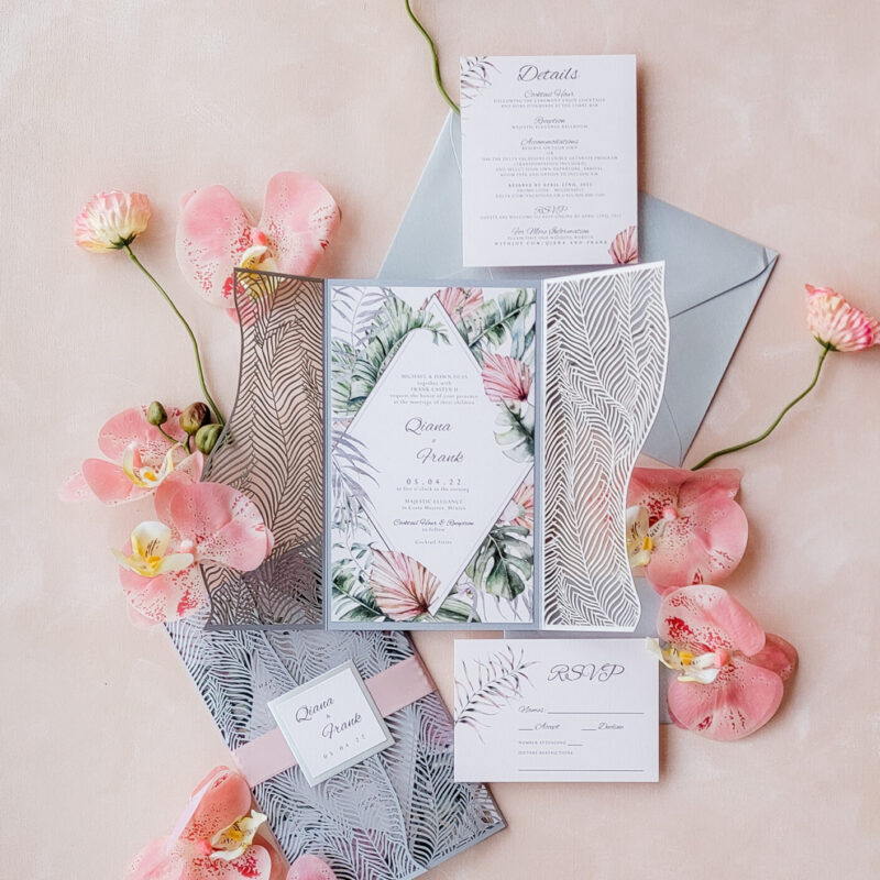 Tropical bohemian wedding invitations featuring pampas grass and lush floral motifs, perfect for destination weddings.