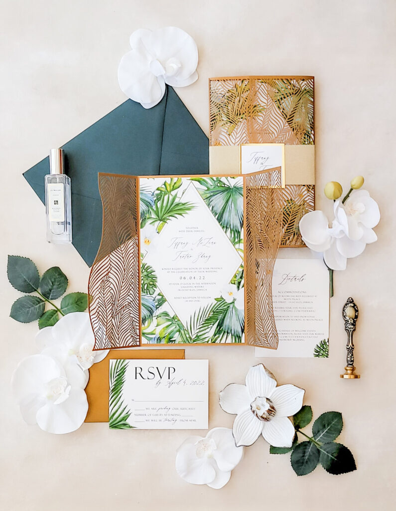 Palm leaf laser cut wedding invitations featuring intricate tropical designs, perfect for luxurious beach or destination weddings.