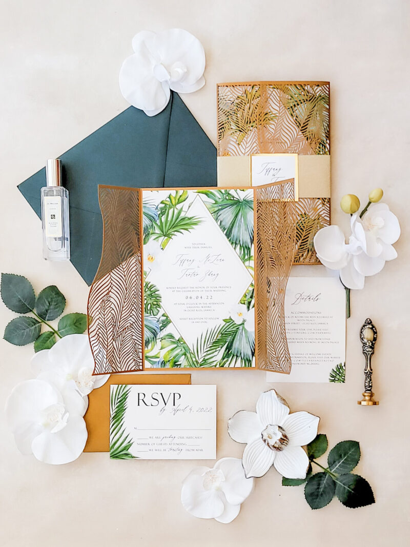 Palm leaf laser cut wedding invitations featuring intricate tropical designs, perfect for luxurious beach or destination weddings.