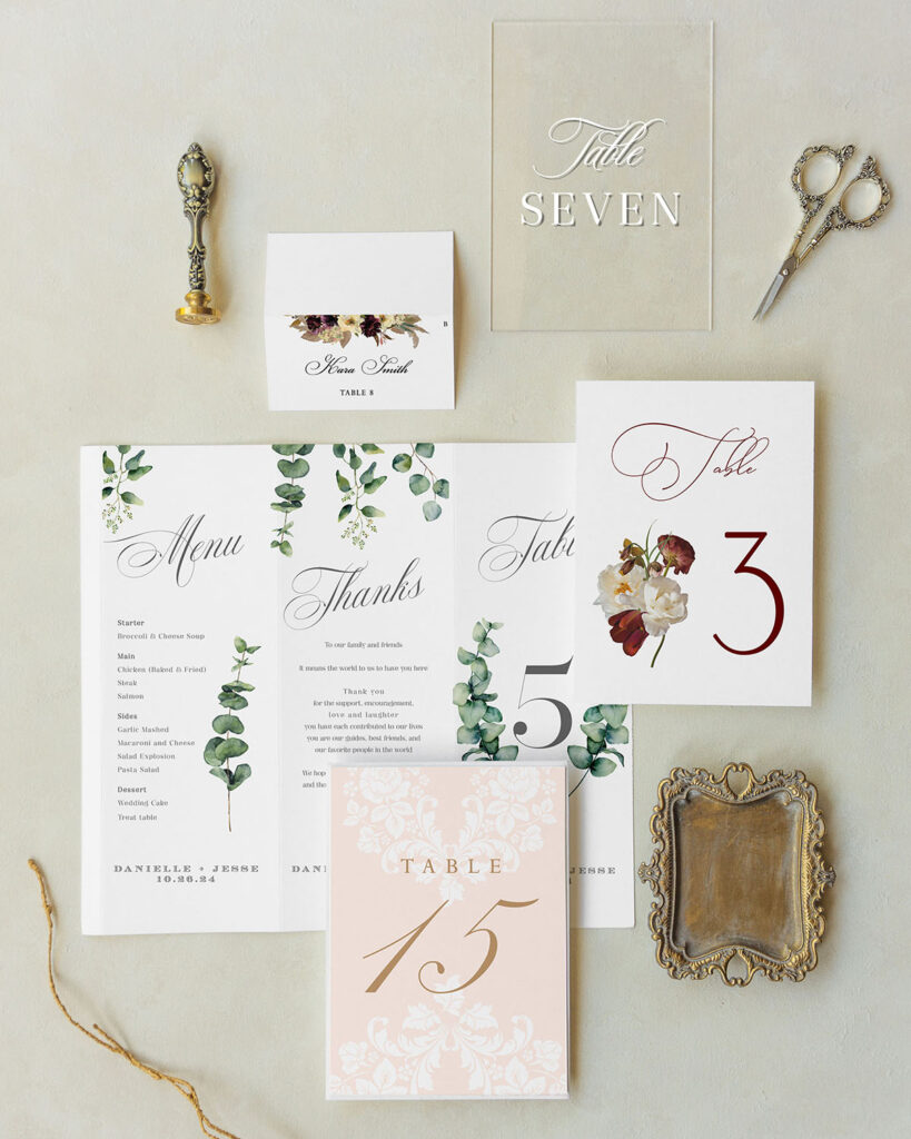 [vc_row][vc_column][vc_wp_text]
TABLE CARDS / TABLE NUMBERS
Table numbers (or table name cards) are usually set at the center of the table, in a frame or on a stand. These can definitely become part of the tablescape.
Our most popular table number styles are:  Rectangular  5″x7″ 1 ply (to use in a frame) – 10 pcs ($2/ea) > $20  Rectangular 5″x7″ duplexed or backed (to use on a stand) – 10 pcs ($4/ea) > $40  Shaped 5″x7″ duplexed or backed (to use on a stand) – 10 pcs ($6/ea) > $60  Standing trifolds 4″x10″ – 10 pcs ($6/ea) > $60  [/vc_wp_text][/vc_column][/vc_row][vc_row][vc_column][vc_column_text][/vc_column][/vc_row][vc_row][vc_column][vc_separator color=