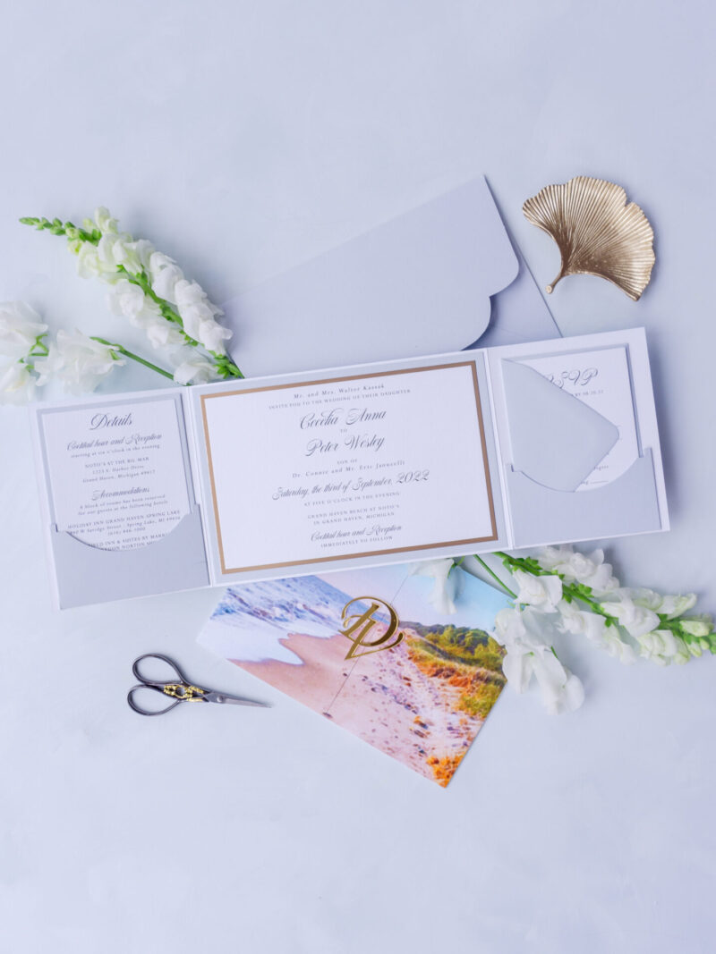 Custom coastal wedding folio invitation with watercolor beach design and acrylic tag.