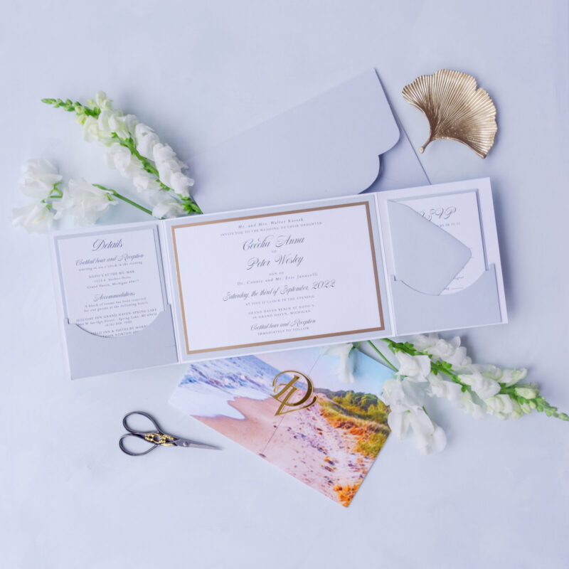 Custom coastal wedding folio invitation with watercolor beach design and acrylic tag.