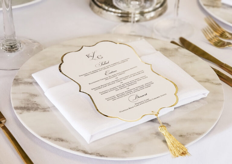 Large ornate wedding menu with gold Mirri cardstock backing, eyelet, and tassel finish