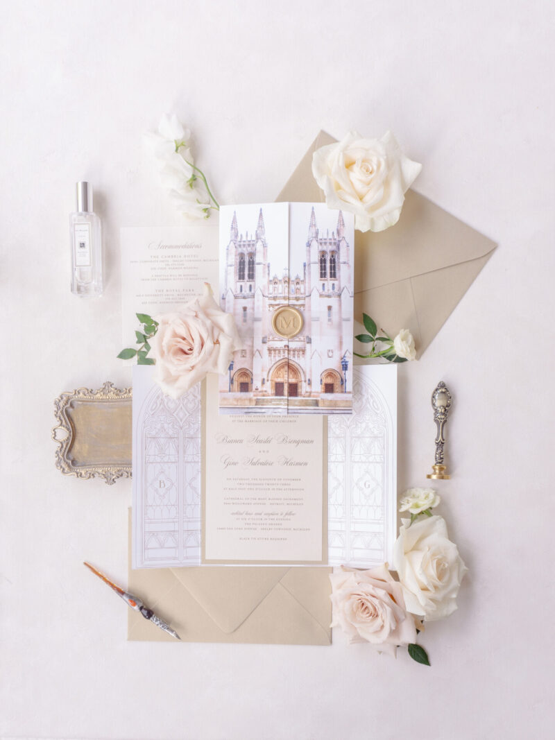 Vertical gate wedding invitation featuring watercolor church artwork and neutral invitation suite