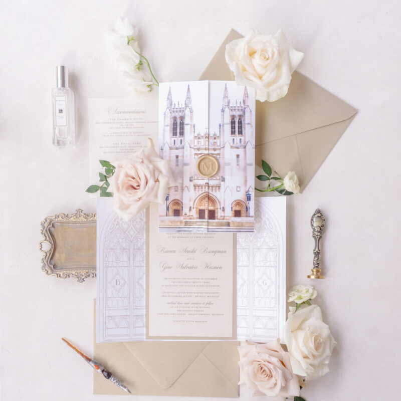Vertical gate wedding invitation featuring watercolor church artwork and neutral invitation suite