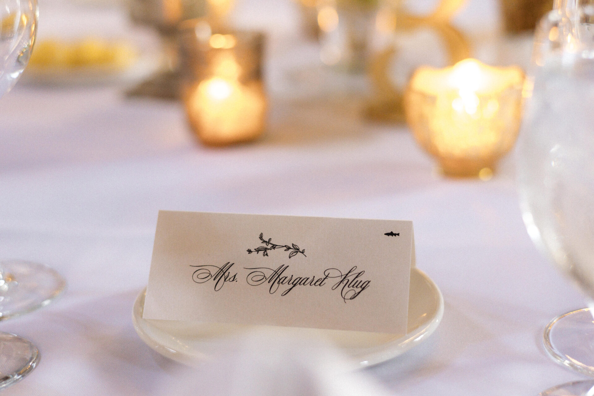 Examples of wedding seating cards, including escort cards, place cards, and seating charts, for reception table arrangements.