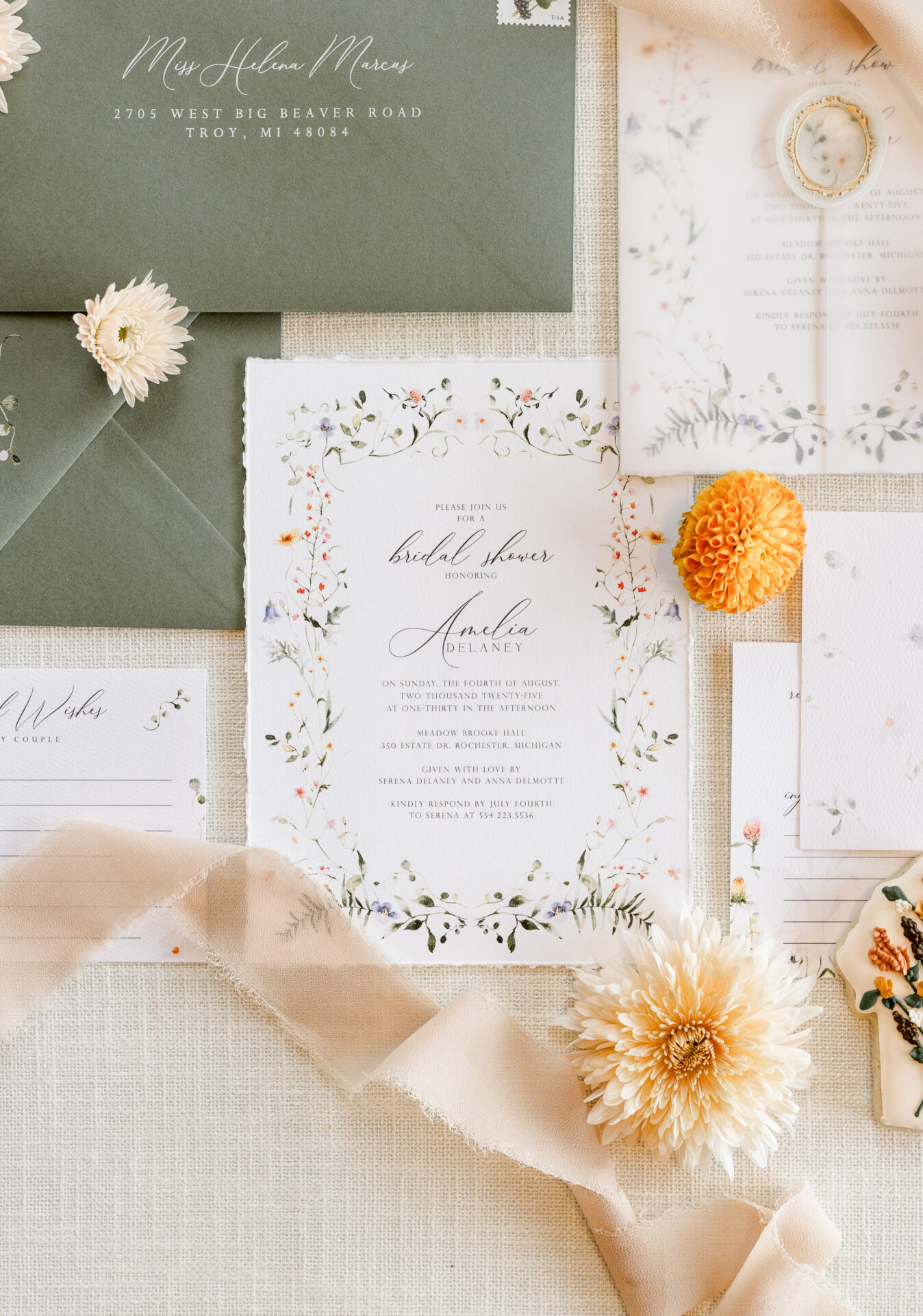 Bohemian wedding table setup with terracotta decor, wildflowers, and custom vellum menus at Neiman Marcus Cafe in Michigan