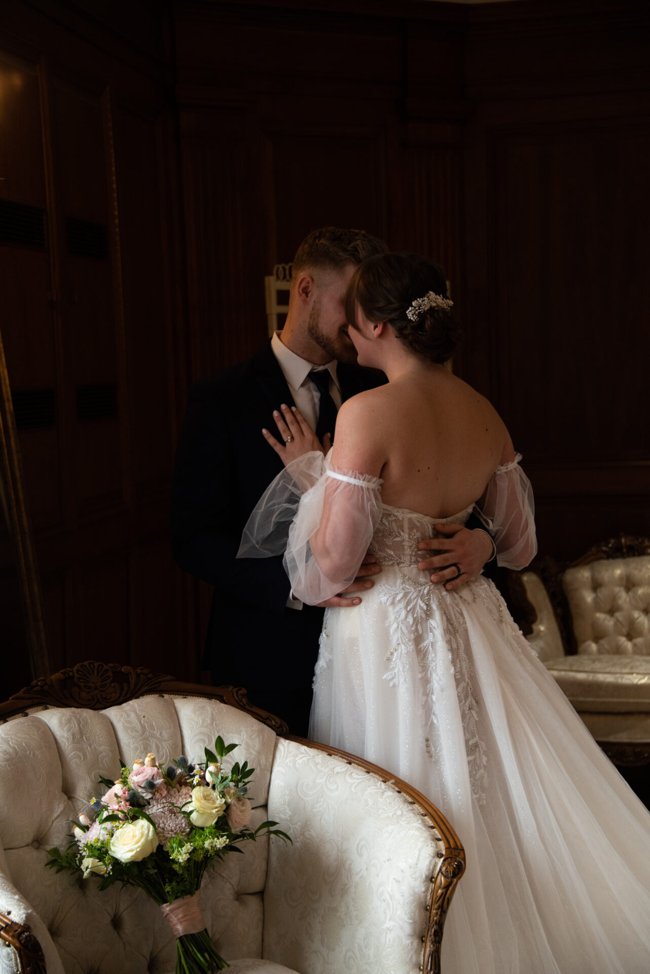 Wedding party showing a range of wedding attire styles from formal gowns to suits and dresses in various fabrics and colors.