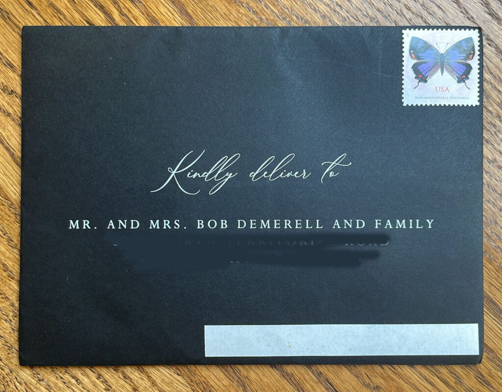 image of a black envelope white ink with a white sticker