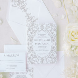 Ornate wedding invitation suite with regency-inspired scrollwork, textured cardstock, and matching envelope liner featuring elegant designs.