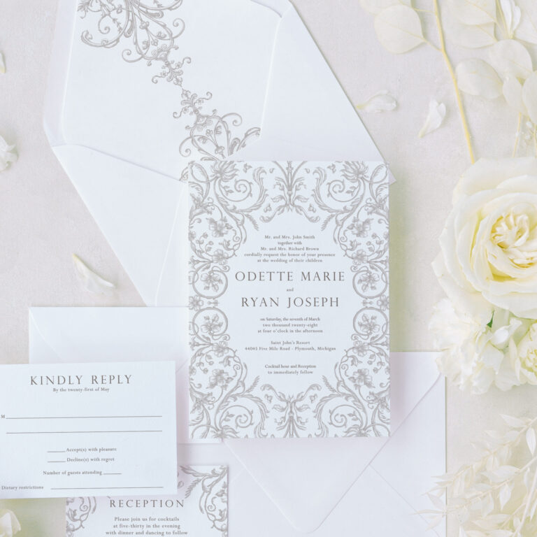 Ornate wedding invitation suite with regency-inspired scrollwork, textured cardstock, and matching envelope liner featuring elegant designs.