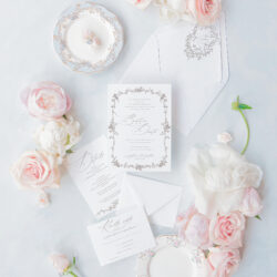 Timeless wedding stationery with romantic script design and intricate floral frame, ideal for formal or elegant weddings.