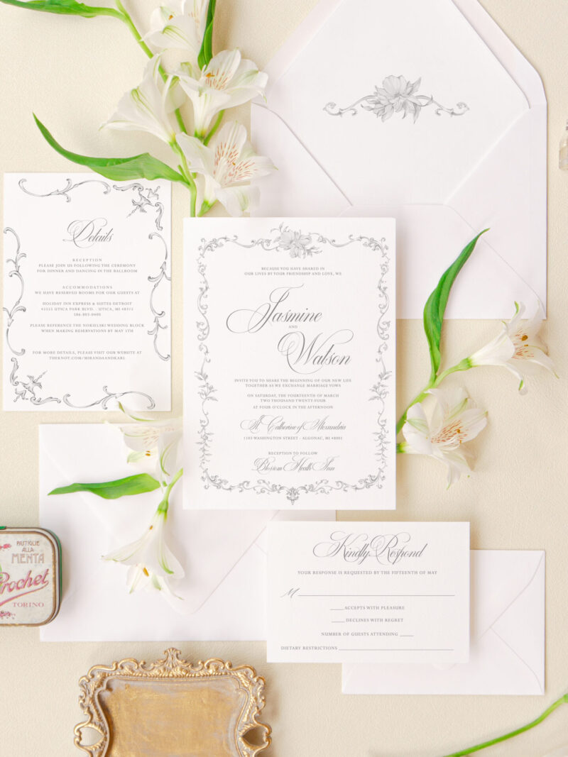 Elegant wedding invitation suite with floral frame design, refined typography, and matching envelope liner