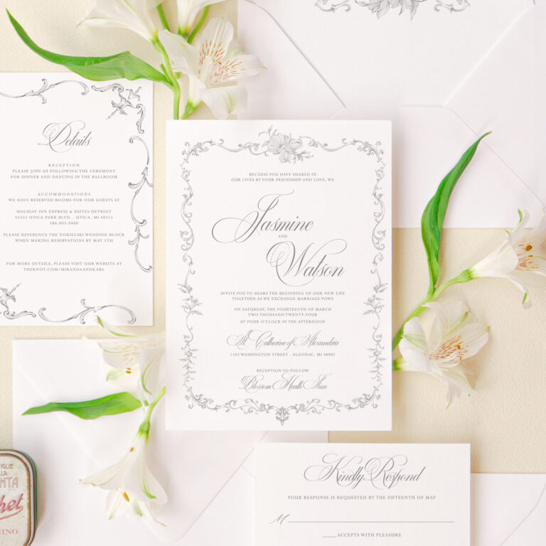 Elegant floral wedding invitations with a detailed frame design and matching envelope liner.