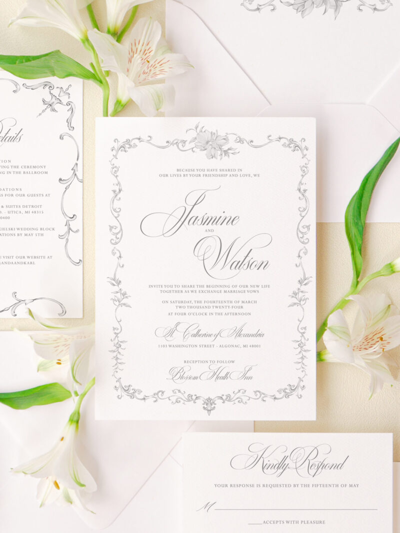 Elegant floral wedding invitations with a detailed frame design and matching envelope liner.