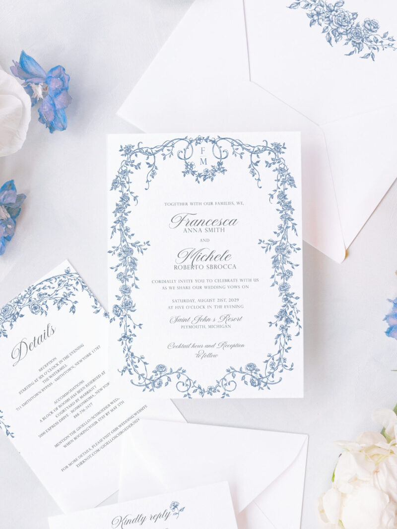 Elegant blue floral wedding invitation suite with Regency-inspired frame design, paired with delicate white and blue florals and styled details.