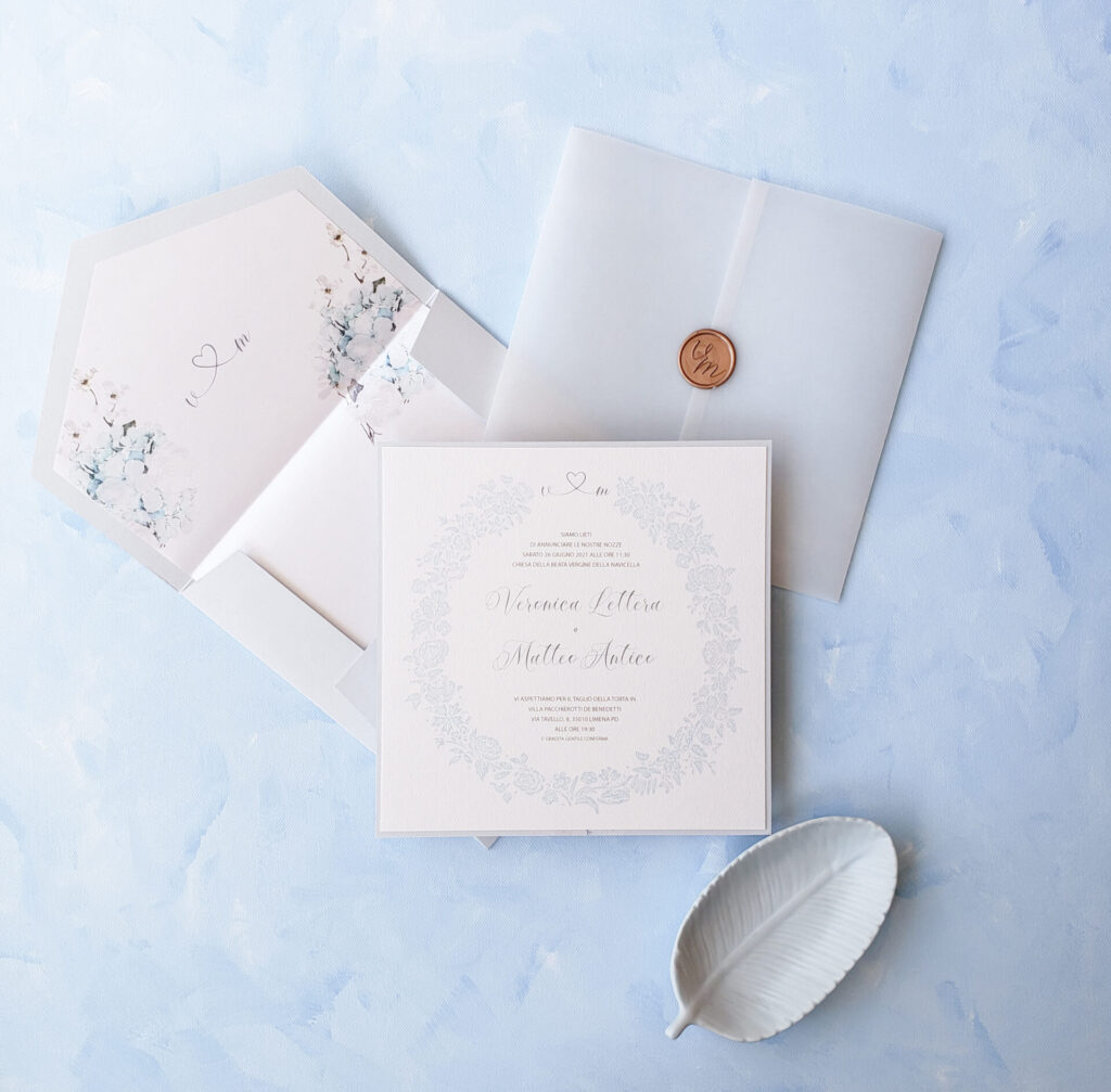 Elegant round wedding menu featuring delicate blue hydrangea artwork, printed on textured cardstock for a refined table setting.