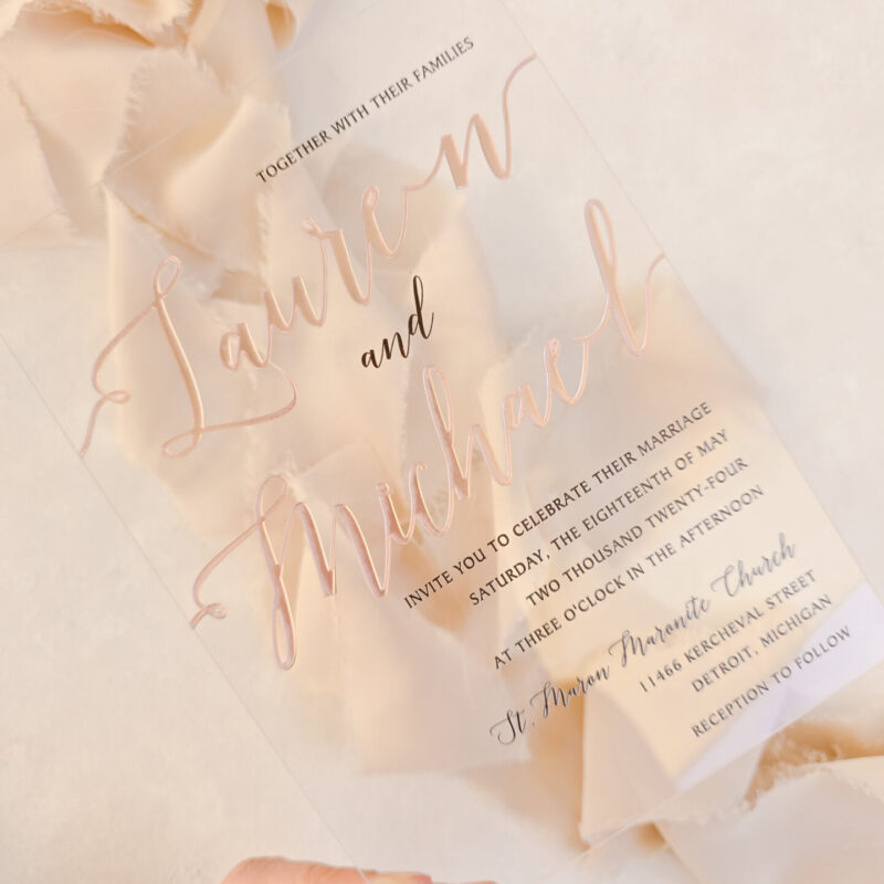 Clear plexiglass invitation with rose gold printing