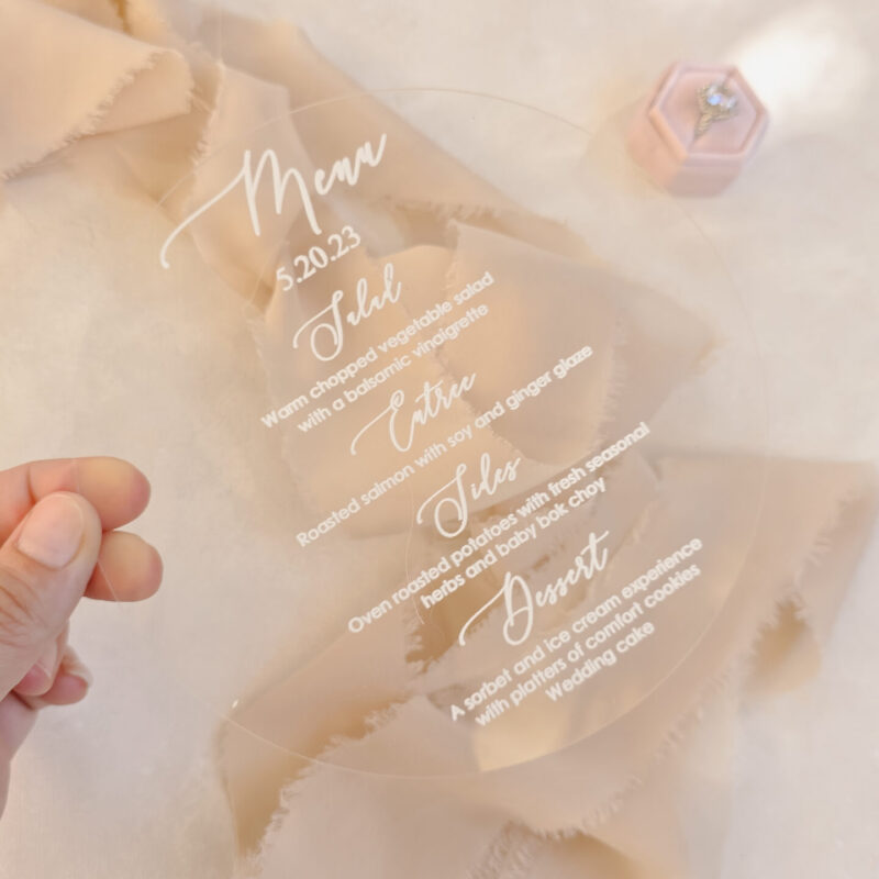 Clear dainty acrylic menu with white letters