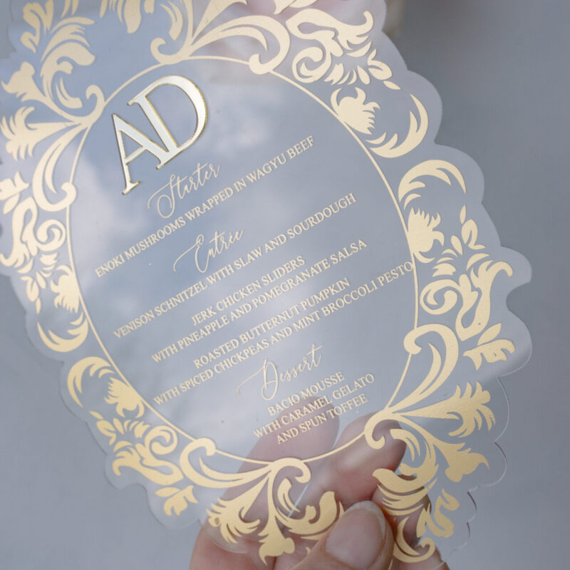 Clear acrylic die cut menu with gold writing