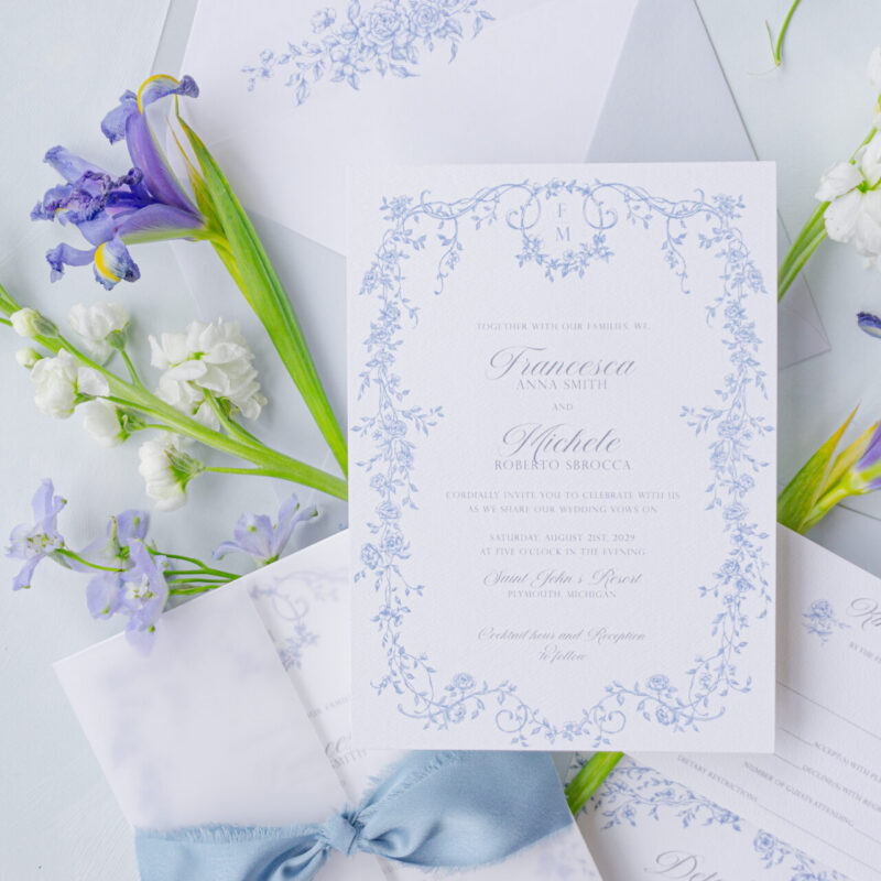 romantic wedding invitation with blue ribbon and vellum